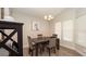 Stylish dining room featuring a dark wood table, four upholstered chairs, and bright windows at 6309 Covewood Dr, Spring Hill, FL 34609