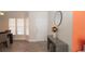 A bright entryway featuring wood-look flooring, an accent table, and a decorative mirror at 6309 Covewood Dr, Spring Hill, FL 34609