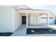 Welcoming front porch with a dark door and bay windows that illuminate the home's entrance at 6309 Covewood Dr, Spring Hill, FL 34609