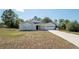 Charming single-story home with well-manicured lawn and a two-car garage on a sunny day at 6309 Covewood Dr, Spring Hill, FL 34609