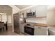 Well-equipped kitchen featuring stainless steel appliances, grey cabinets, and stylish countertops at 6309 Covewood Dr, Spring Hill, FL 34609