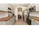 A stylish, modern kitchen with wood counters, gray cabinets, and stainless steel appliances at 6309 Covewood Dr, Spring Hill, FL 34609