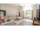 Comfortable living room showcases a large window, patio access, and a neutral color scheme at 6309 Covewood Dr, Spring Hill, FL 34609