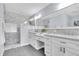 Modern bathroom featuring a dual vanity, marble-tiled shower, and stylish finishes at 6454 Summerfield Loop, Trinity, FL 34655