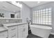 Stylish bathroom with a soaking tub, updated vanity, and modern fixtures at 6454 Summerfield Loop, Trinity, FL 34655