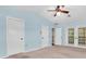 Bedroom features closet and french doors at 6454 Summerfield Loop, Trinity, FL 34655