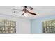 Bedroom features ceiling fan and natural light at 6454 Summerfield Loop, Trinity, FL 34655