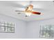 Bright bedroom featuring neutral paint, ceiling fan and natural light from large windows at 6454 Summerfield Loop, Trinity, FL 34655