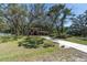 A picturesque home sits on a sprawling lot with lush landscaping and a long, inviting driveway at 6454 Summerfield Loop, Trinity, FL 34655