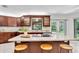 Modern kitchen with an island cooktop, granite countertops, stylish cabinets, and stainless steel appliances at 6454 Summerfield Loop, Trinity, FL 34655