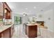 Bright kitchen with a large island, granite countertops, a cooktop, and an open view to the living area at 6454 Summerfield Loop, Trinity, FL 34655