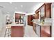 Kitchen with stainless steel appliances, granite countertops, a center island with a cooktop, and ample storage space at 6454 Summerfield Loop, Trinity, FL 34655
