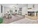 Spacious living room with a fireplace, plush carpeting, and plenty of natural light at 6454 Summerfield Loop, Trinity, FL 34655