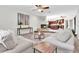 Inviting living room with plush sofas, a fireplace, and an open layout to the kitchen at 6454 Summerfield Loop, Trinity, FL 34655