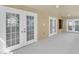 Covered patio with multiple doors for outdoor living at 6454 Summerfield Loop, Trinity, FL 34655