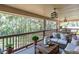 Inviting outdoor patio with comfortable seating, wooden furniture and green view at 6454 Summerfield Loop, Trinity, FL 34655