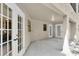 Covered patio with multiple doors for outdoor living at 6454 Summerfield Loop, Trinity, FL 34655