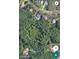 An aerial view of a luxury home surrounded by lush greenery, featuring a private pool and ample space at 6454 Summerfield Loop, Trinity, FL 34655