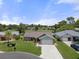 Aerial shot of a home with lush landscaping, mature trees and a beautiful lawn at 7175 Bottle Brush Dr, Spring Hill, FL 34606