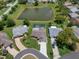 Aerial shot showcasing the home's location near a tranquil pond and surrounded by lush greenery at 7175 Bottle Brush Dr, Spring Hill, FL 34606