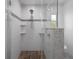 Modern bathroom featuring a walk-in shower with glass enclosure and decorative pebble floor at 7175 Bottle Brush Dr, Spring Hill, FL 34606