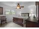 Comfortable bedroom with a ceiling fan and natural light from the window at 7175 Bottle Brush Dr, Spring Hill, FL 34606