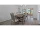 Elegant dining area with modern chandelier and seating for six, with views of the lanai at 7175 Bottle Brush Dr, Spring Hill, FL 34606