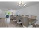 Open-concept living and dining area with stylish furniture and plenty of natural light at 7175 Bottle Brush Dr, Spring Hill, FL 34606