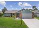 Well-maintained one-story home featuring a two-car garage and manicured front yard at 7175 Bottle Brush Dr, Spring Hill, FL 34606