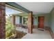 Inviting covered porch with brick columns and a cozy seating area at 7175 Bottle Brush Dr, Spring Hill, FL 34606