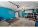 Spacious garage with painted walls, ceiling fan, refrigerator, and storage at 7175 Bottle Brush Dr, Spring Hill, FL 34606
