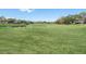Expansive, well-maintained golf course with a scenic pond, providing a tranquil and enjoyable recreational space at 7175 Bottle Brush Dr, Spring Hill, FL 34606