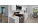 Contemporary kitchen featuring granite countertops, stainless steel appliances, and an electric cooktop at 7175 Bottle Brush Dr, Spring Hill, FL 34606