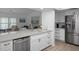 Open kitchen with stainless steel appliances, stone countertop island, and gold fixtures at 7175 Bottle Brush Dr, Spring Hill, FL 34606