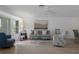 Cozy living room showcasing a stylish sofa, accent chair, and a glass-top coffee table with natural lighting at 7175 Bottle Brush Dr, Spring Hill, FL 34606
