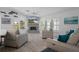 Open living room with a gray brick fireplace, neutral décor, and plenty of natural light at 7175 Bottle Brush Dr, Spring Hill, FL 34606