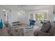 Well-lit living room featuring modern decor, a bay window, and comfortable seating arrangements at 7175 Bottle Brush Dr, Spring Hill, FL 34606