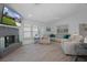 Spacious living room features a gray brick fireplace, large windows, and neutral décor at 7175 Bottle Brush Dr, Spring Hill, FL 34606