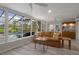 Relaxing sunroom provides clear views of the pool and landscaped backyard at 7175 Bottle Brush Dr, Spring Hill, FL 34606