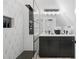 Stylish bathroom with a walk-in shower, dual sink vanity, and modern fixtures at 7422 New York Ave, Hudson, FL 34667