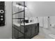 A modern bathroom with dual vanities and a black frame shower at 7422 New York Ave, Hudson, FL 34667
