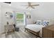 Relaxing bedroom space has a ceiling fan, a stylish seating area, and decor at 7422 New York Ave, Hudson, FL 34667