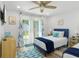 Bedroom featuring two beds, coastal-themed decor, and sliding glass door to backyard at 7422 New York Ave, Hudson, FL 34667