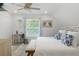 Comfortable bedroom boasts a ceiling fan, ample closet space, and a stylish desk area at 7422 New York Ave, Hudson, FL 34667