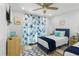 Bedroom featuring two beds, coastal-themed decor, and a ceiling fan at 7422 New York Ave, Hudson, FL 34667