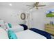 Bright bedroom featuring two beds, ceiling fan, closet, and TV at 7422 New York Ave, Hudson, FL 34667