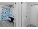 View of a bedroom featuring coastal decor leading to a bathroom with shower at 7422 New York Ave, Hudson, FL 34667