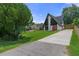 A-frame residence showing off unique structure, well-manicured lawn, and spacious driveway at 7422 New York Ave, Hudson, FL 34667