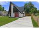 A-frame home showcasing unique architecture, bright red doors, and a well-maintained front yard at 7422 New York Ave, Hudson, FL 34667