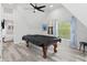 A recreation room is highlighted by a covered pool table, and light grey floors at 7422 New York Ave, Hudson, FL 34667